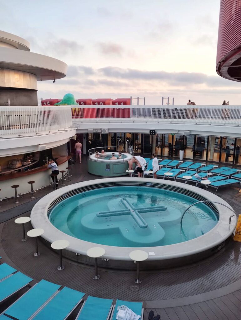 a large hot tub with seating and a bar
