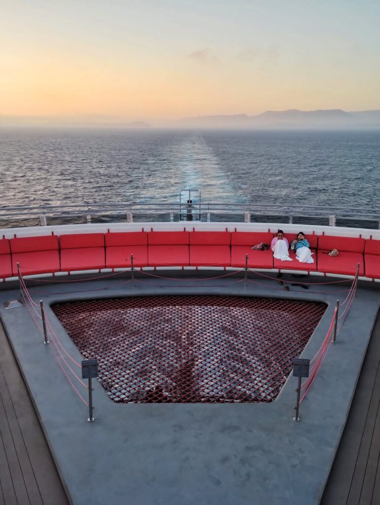 sailing away on a cruise ship with the land behind