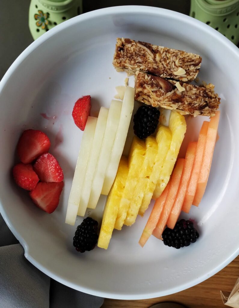 a bowl of chopped fruit and berries