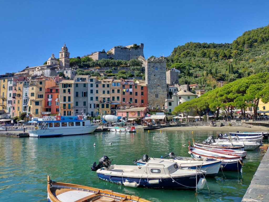 boats on the sea with colourful buildings in the background