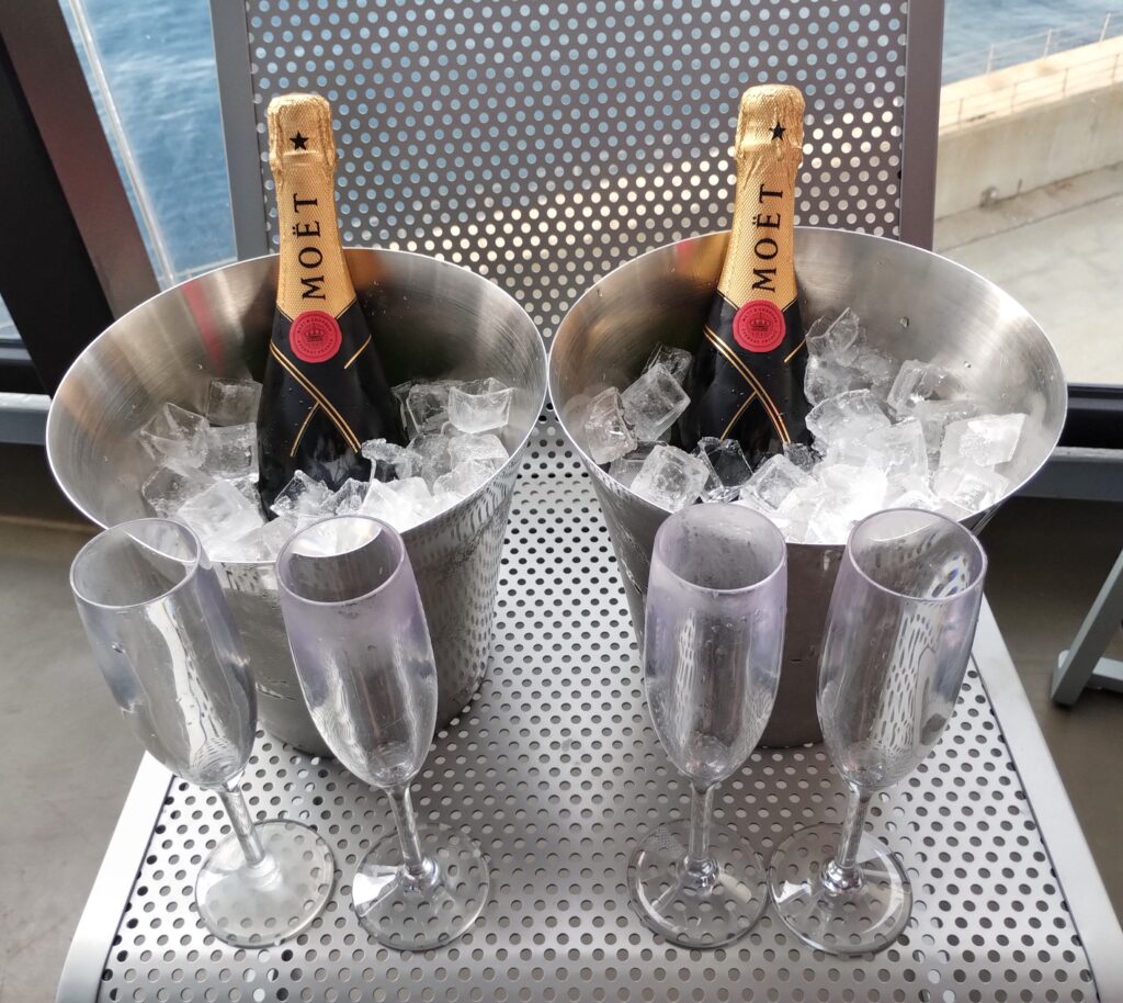 two bottles of champagne in buckets of ice