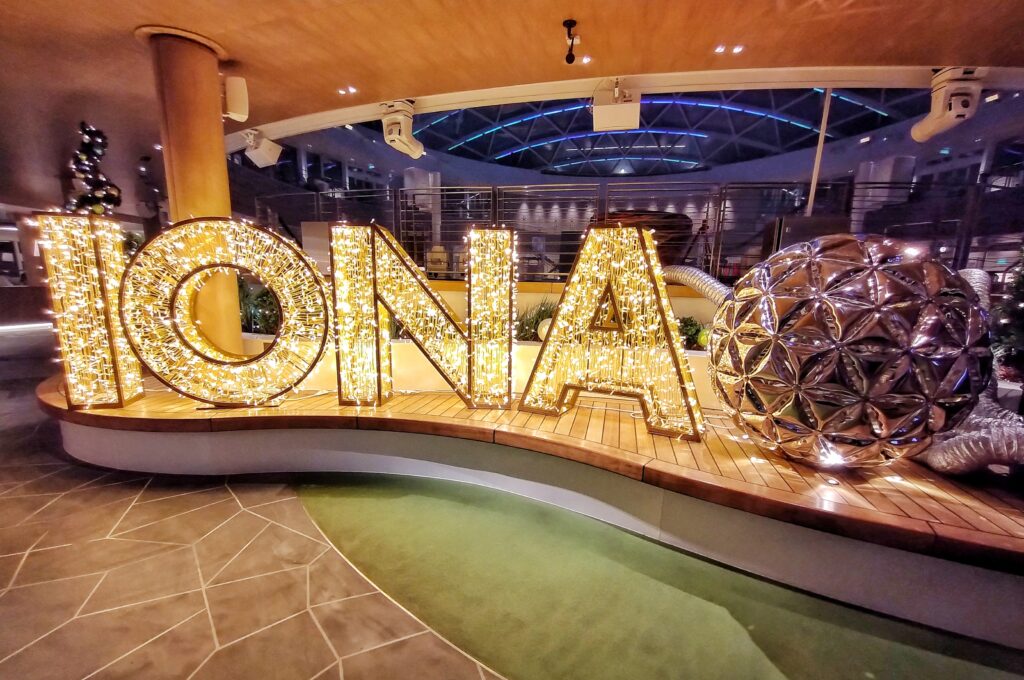 The Iona sign lit up with Christmas lights