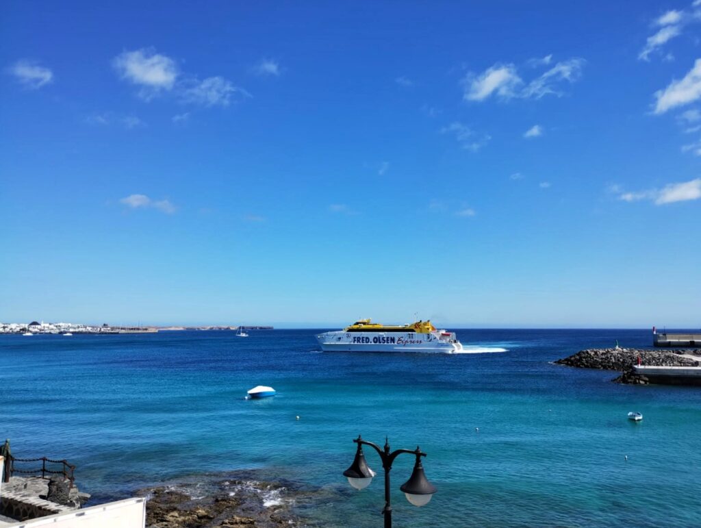 a ferry crossing the blue sea