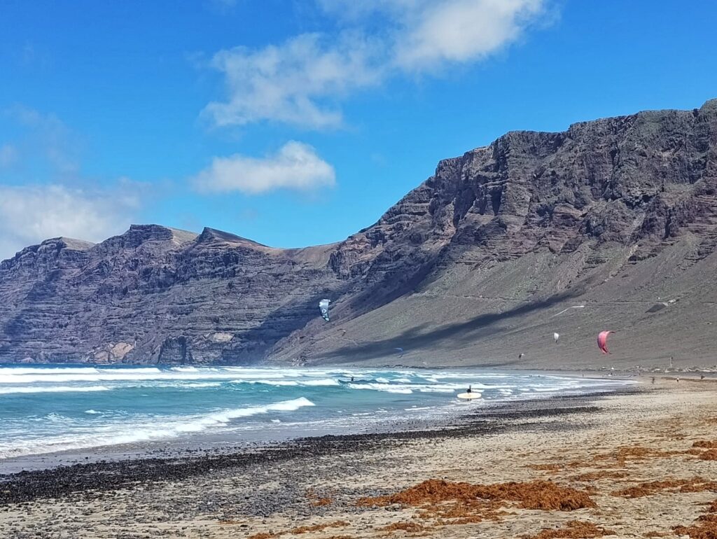 people kite surfing on the beach