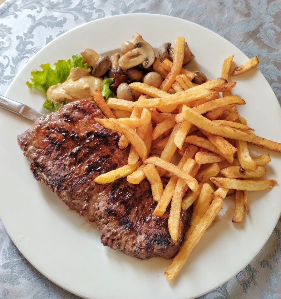 steak and chips on a white plate