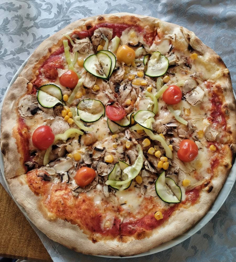 a pizza with fresh vegetables 