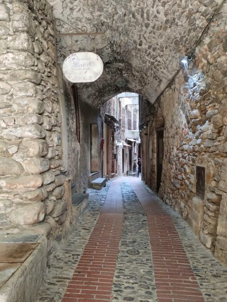 Narrow cobbled alleyway winding through the old town of Dolceacqua
