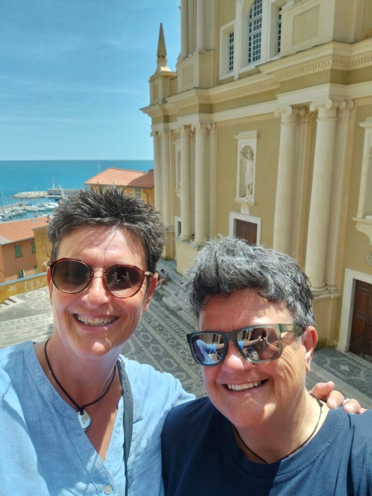 two people doing a selfie in front of a church