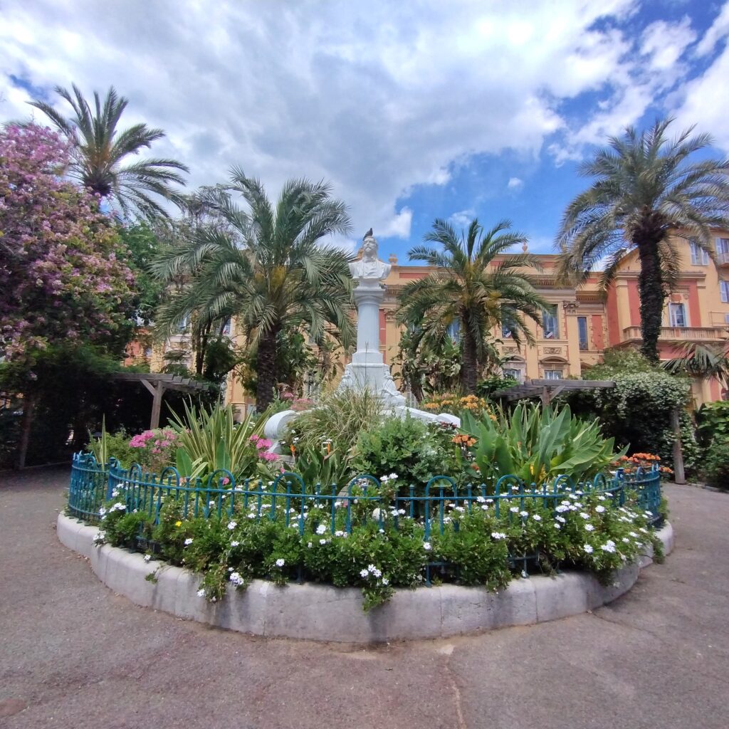 circular plants and flowers with a statue