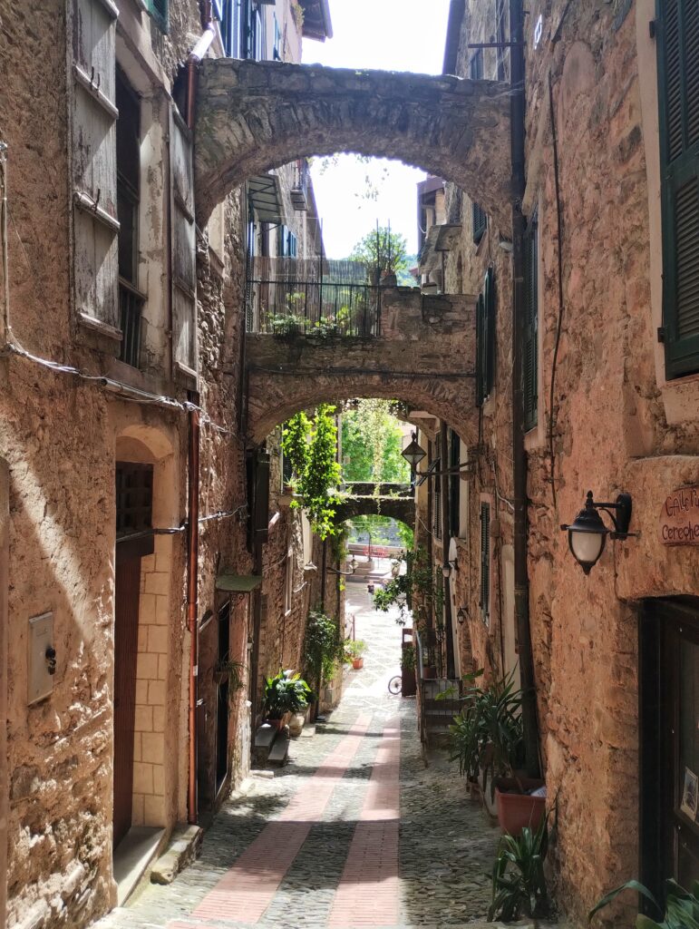Shaded stone street with archway in Dolceacqua, Italy’s Ligurian village