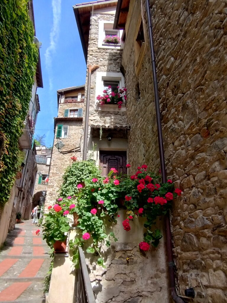 Stone Ligurian house façade with flower boxes in Dolceacqua